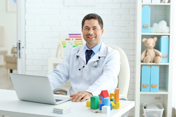 Pediatrician working at his office