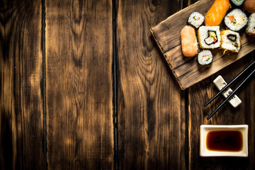 Sushi and rolls seafood with soy sauce.