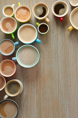 Obraz na płótnie Canvas Cups of coffee on wooden background, top view