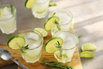 Cold fresh cocktails with lime on cutting board