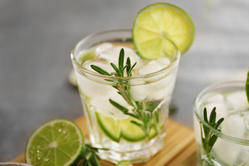 Cold fresh cocktail with lime on table