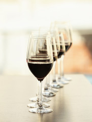 Glasses with red wine in a row on a table
