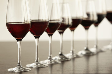 Glasses with red wine in a row on a table