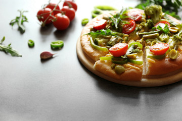 Plate with tasty vegetarian pizza on table