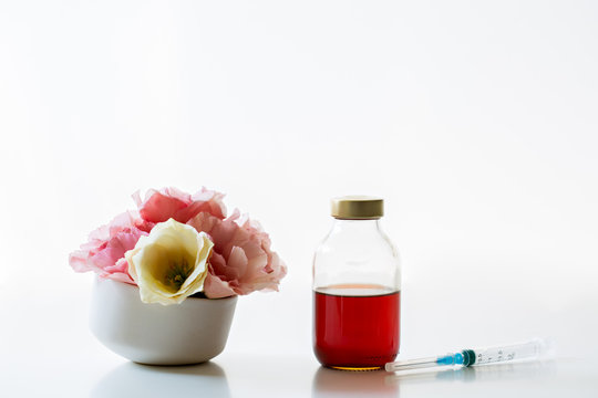 Medical bottle with liquid for injection and eustoma flowers 