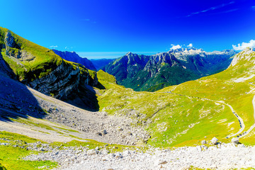 Beautiful alps landscape. Beautiful majestic mountain peaks with paths and cars of tourists.