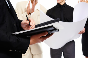 Signing a document. People at business meeting. Studio shot