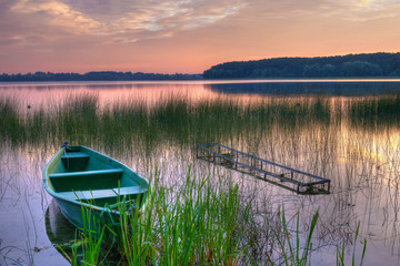 Rowing boat floating over the Lake Lasmiady  waters. Masuria, Poland. HDR image