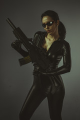 Fototapeta na wymiar Machinegun, Brunette woman with enormous bulletproof vest and gu