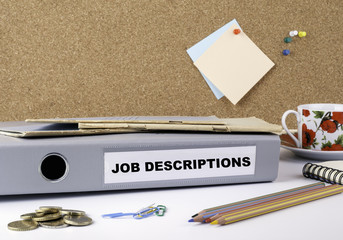 Job Descriptions  - folder on white office desk.