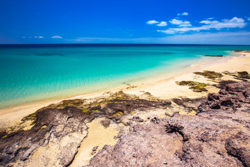Obraz premium Costa Calma sandy beach with vulcanic mountains in the background, Jandia, Fuerteventura island, Canary Islands, Spain.