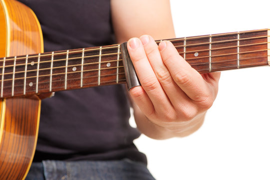Man's hands playing an acoustic guitar
