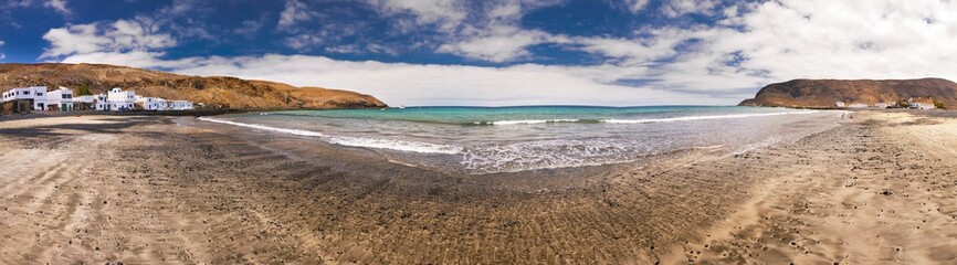 Fishing village Pozo Negro with stone and sand beach, Fuerteventura, Canary Island, Spain.