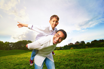 Portrait of an international family playing tablet PC in in the park