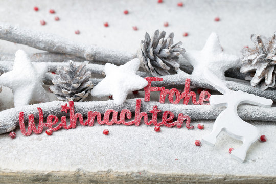 Red letters with german Frohe Weihnachten means Merry Christmas.