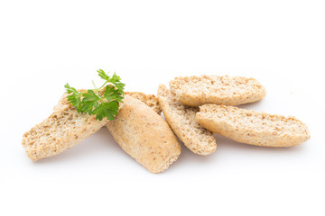 Dry flat bread crisps with herbs on a white background.