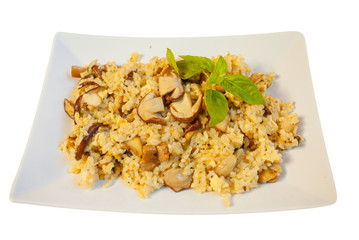  hot risotto with mushrooms on white plate on white background