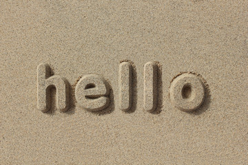 Hello written in sand letters