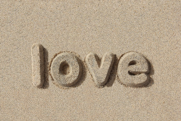 Love written in sand letters