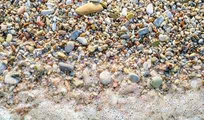 Pebbly beach and little wave background