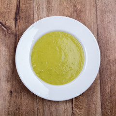 Vegetable split pea soup on a wooden background