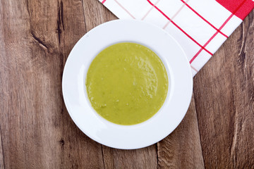 Vegetable split pea soup on a wooden background