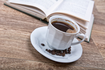 A cup of coffee with a book