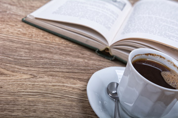 Fototapeta na wymiar A cup of coffee with a book