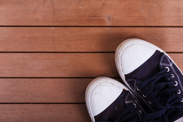 Old canvas shoes on a wooden floor