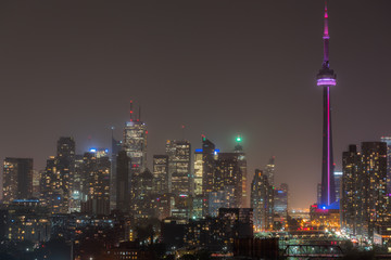 Urban lighted landscape & skyline of Toronto.   Rooftop panoramic of city skyline of buildings & office towers on a hot, humid August night in the capitol of Ontario, Canada,