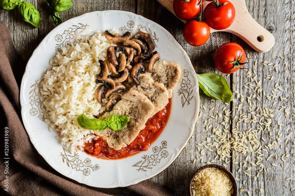 Wall mural Fried pork cutlets with rice, tomato and mushrooms