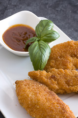 Chicken Fingers and BBQ Sauce with Basil Leaves