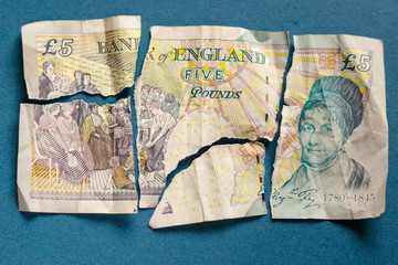 Old 5 pounds paper note torn apart