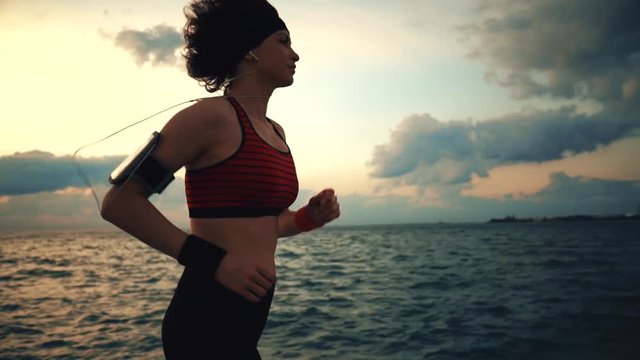 Runner athlete start running at seaside with skyscrapers on the background