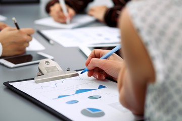 Group of business people at meeting  discussing financial results. Women pointing into laptop computer monitor