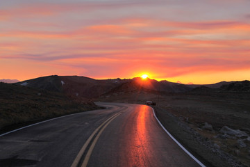 Fototapeta na wymiar Mountain road under sun set