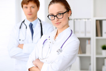 Fototapeta premium Happy doctor woman with medical staff at the hospital