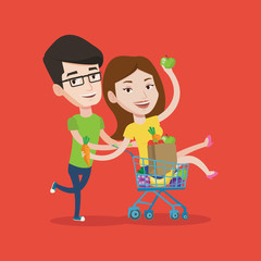 Couple of friends riding by shopping trolley.