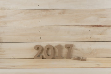 Sigh symbol from number 2017 on   wooden texture background. Empty copy space for inscription or other objects Idea merry new year holiday year of cock. old year 2016.