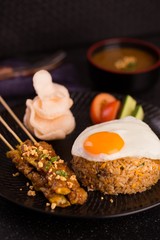 Special rice style of nasi goreng with egg, roasted meat, cracke
