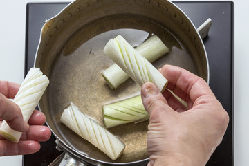 Preparing sliced onion for cooking in the kitchen