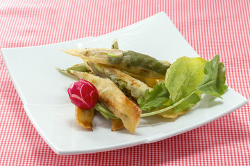Tempura of shrimp meat with fresh red radish and cabbage on whit