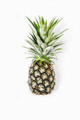 Top view of pineapples on wooden table over white background