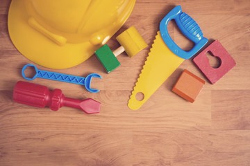 Flat lay - toys tools on laminated wood floor.