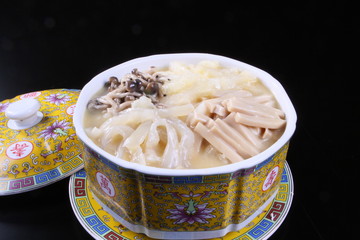 Mushroom soup in chinese bowl on black background