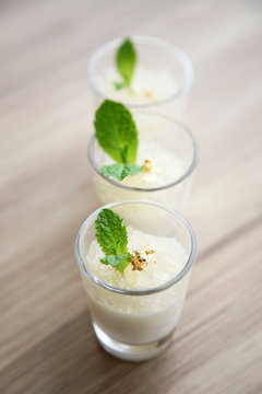 Milk pudding with fish maws and mint leaf in glasses