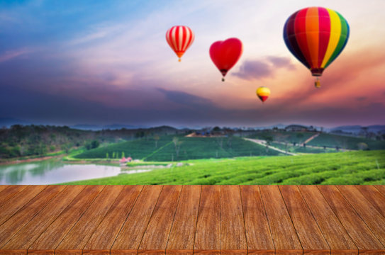 Wood table top on hot air balloons background - can used for dis