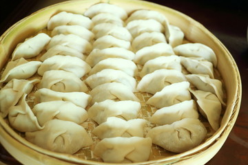 Chinese dumplings on the bamboo tray for steaming