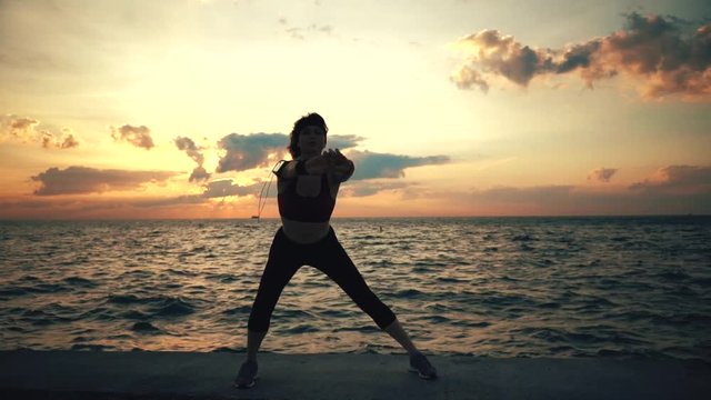 Runner athlete doing exersises at seaside