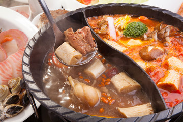 Hot pot of pork, seafood and mushroom in restaurant